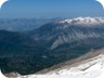 Cajupi Mountain seen from Papingut, the summit of Nemercke Mountain. The view goes across the Zagoria valley. The main peak of Cajupi, and to its left the more rocky pinnacle can be clearly made out. Gjirokaster is behind Cajupi Mountain. The picture was taken a year earlier, but around the same time of the year (early May).