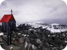 View south along the ridge of Skenderbeut Mountain. The highest point is Mali i Liqenit (see separate trail). This wayside cross is near the lone tree near the summit of Maja e Hutit.