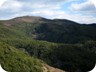 Korbit - the higher of the two summits is the left summit, covered in trees