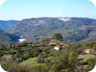 View west from Korre. The white wall is the new dam that is going to create a lake, and hydropower, in the years to come. The canyon of the river Zalli i Korres will disappear. The white cloud is dust from the quarry that  is eating into the mountain, which on its right side is home to Pellumba cave.