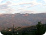 Mali i Polisit, with the village of Gurshpatë. The road goes up to the lower plateau on the right side of the mountain - from there it is still more than  864 m to climb and 7.5 kilometer to walk to the summit