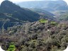 In the village of Shënkoll. The trail passes the green field in the center of the image, and continues towards the left on top of the eroded parts.