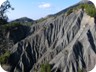 Dramatic views across the ravines. The rocks and castle of Petrele are barely visible, and appear tiny compared to the canyons and the spectacle they provide