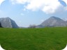 Grassy fields, with Kruja Mountain on the left and Kavaise on the right.