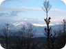 On the summit of Kodra e Luncit. Mali i Fagut on the left and the pyramid of Mali i Snojt (right, between the trees) in the distance. Both mountains are covered by separate trails on Wikiloc