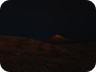 At night, the crater illuminates the surrounding hills...