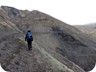 Negotiating muddy paths to the cave and prayer flags